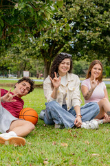 Fototapeta premium Vertical portrait of friends making the sign language I Love You gesture