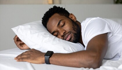 Young Black man sleeping peacefully on a white pillow with a smartwatch on his wrist