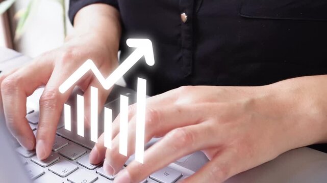 Review performance statistics. Close-up of a businesswoman's hands on her computer with an animated graph icon and an upward-pointing arrow.