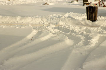 snow on the road with tire tracks