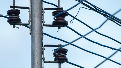 electricity post with blue sky background, closeup of photo.