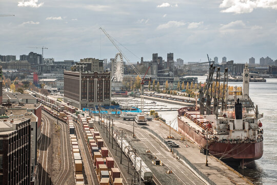 Industrial port of Montreal with container trains, cargo ship, logistics infrastructure, highlighting transportation, imports, exports and commercial activity in one of North Americas major trade hubs