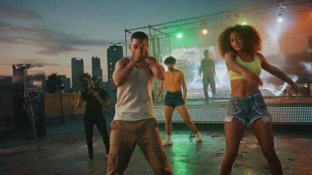 Reggaeton music video with a rapper performing in front of backup dancers