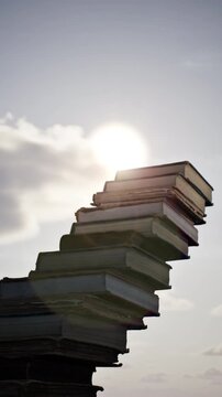 Concept idea stack of books on sky sun Rise beautiful background. 3D animation. 4K.	
