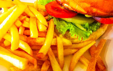 Crispy chicken or beef burger cheeseburger hamburger salad French fries.