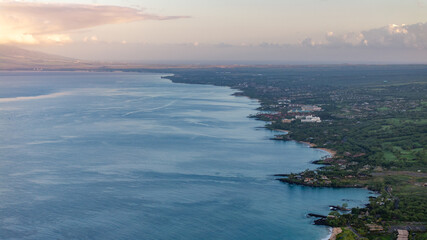Panoramic aerial view captures Maui, Hawaii coastline seascape with lush landscapes and clear waters during morning sunrise in Wailea-Makena