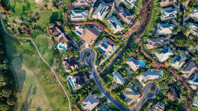 Bird's eye aerial view of vacation homes and condos with lush greenery landscaping in town of Wailea in Maui, Hawaii 