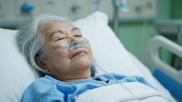 elderly patient in hospital bed with nasal cannula resting peacefully