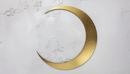 A gold crescent moon sculpture on a white marble surface with a subtle gray veining pattern, conveying a sense of Ramadan celebration.