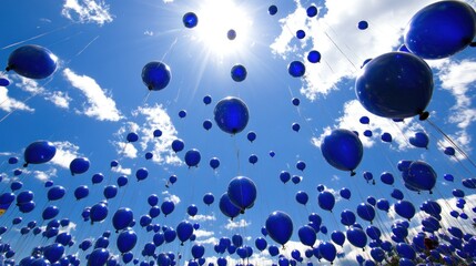Blue balloons soaring in sunny sky uplifting joyful stock photo