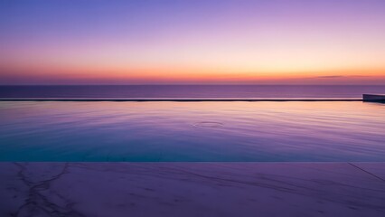 Serene infinity pool overlooking calm ocean waters at sunset with vibrant purple, pink, and orange hues in the sky, reflecting on the water's surface, perfect