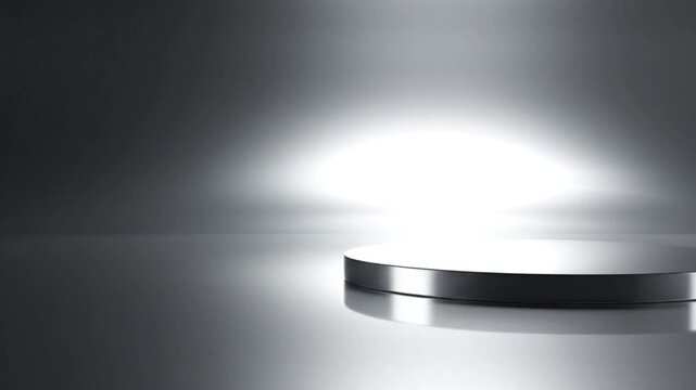 A metallic cylindrical object with a spotlight shining on it, creating a gradient of light and