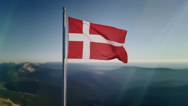 Denmark flag waving on mountain peak with breathtaking landscape