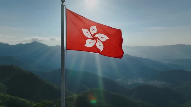 Hong Kong flag waving in the wind with a stunning mountain landscape