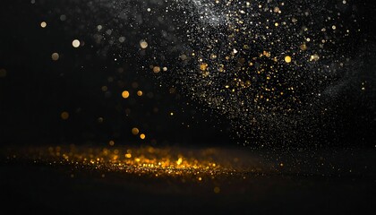 Close-up of gold particles floating against a dark, blurred background, with illuminated floor reflections