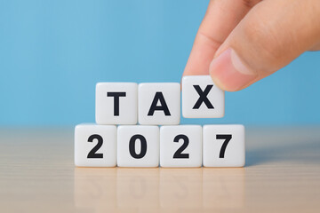 TAX in 2027 concept, on wooden block. State taxes,tax payment, governant ,calculating finance, tax accounting, statistics and data analytic reserach, calculation tax return, strategy plan, report