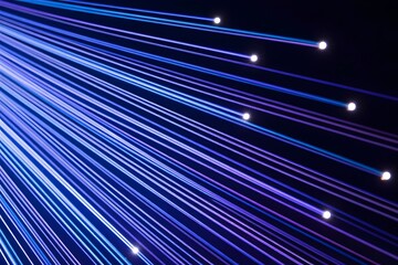 Illuminated strands of light converge from a central point against a dark backdrop