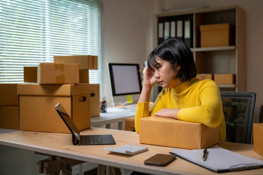 Stressed asian female entrepreneur having problems with her online business - Powered by Adobe