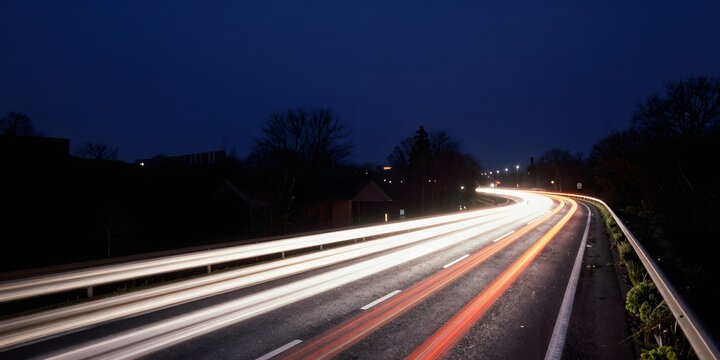 Long exposure shot of car light trails on highway at night - Powered by Adobe