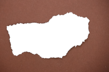 Ripped transparent hole in brown paper