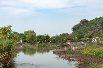 Fototapeta premium Traditional Vietnamese Tombs Surrounded by Limestone Mountains in Ninh Binh, Vietnam