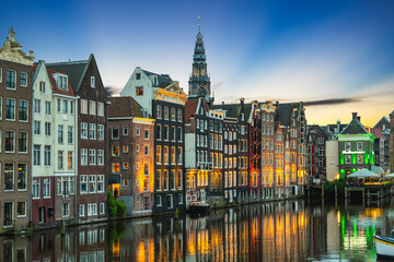 Scenery of Damrak in Amsterdam, Dutch. The houses located direct on the water