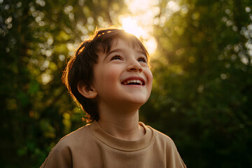 Happy Smiling Child Looking Up Outdoors at Sunset, Joyful Childhood and Natural Light Portrait