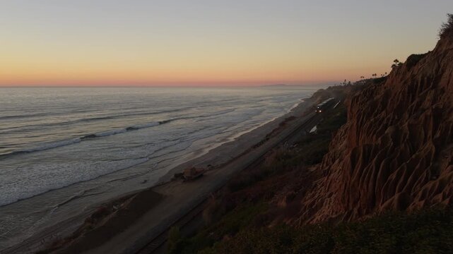 Pacific Surfliner at sunset in Del Mar, California. Static shot of train going by with ocean background.