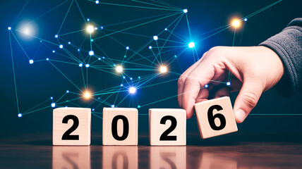 A digital marketing and technology-themed image showing wooden blocks with numbers 2026 arranged on a reflective dark surfac