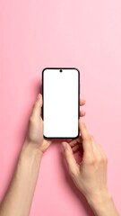 Hands holding blank smartphone, against soft pink background, vertical orientation, clean, minimalist