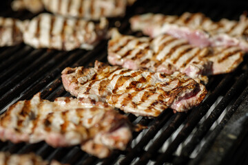 Grilled chicken breast on an outside charcoal metal grill