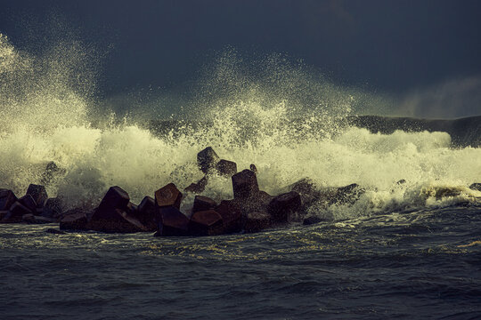 The waves hit the wave-breaking blocks to form stunning and beautiful waves Amazing power of nature For branding,calendar,postcard,screensaver,wallpaper,poster,banner,cover,website High quality photo