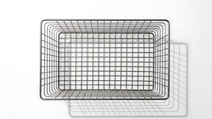 Geometric wire basket casting shadow on pristine white surface, studio shot