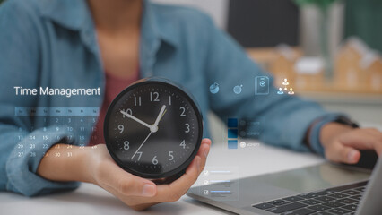 Businessman holding a clock for time management. Using laptop with virtual calendar interface,...