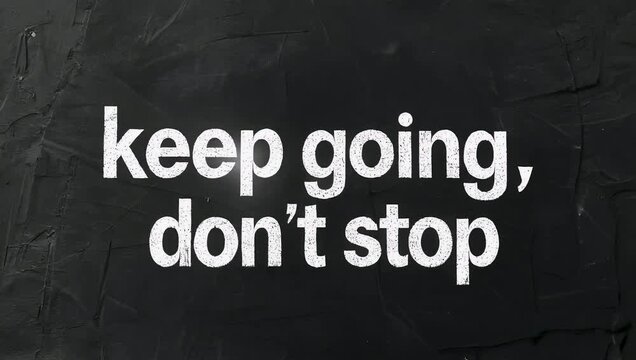 Minimalistic 4K typography animation displaying bold white text on black background reading keep going don&rsquo;t stop designed to inspire motivation 