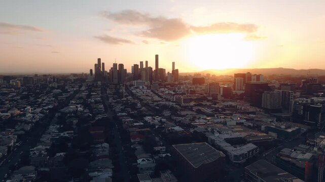 High drone of tightly packed residential blocks glowing beneath fading sunset sky, CBD Teneriffe Brisbane Queensland Australia