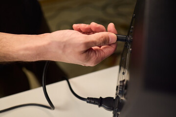 Setting up audio connection professionally, Attaching sound cable to subwoofer in studio, Closeup of hands securing audio cable into subwoofer in recording studio setting © Евгений Вершинин
