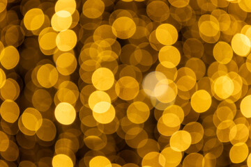 Abstract blurred golden light circles form a bright shimmering texture, ideal for luxury themes, New Year celebrations, digital wallpapers and stylish advertising layouts.