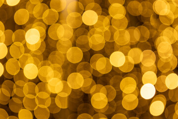 Abstract blurred golden light circles form a bright shimmering texture, ideal for luxury themes, New Year celebrations, digital wallpapers and stylish advertising layouts.