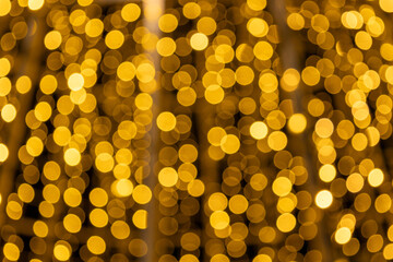 Soft golden bokeh lights create a warm festive background, perfect for Christmas cards, holiday banners, party invitations and elegant seasonal designs with a cozy night atmosphere.
