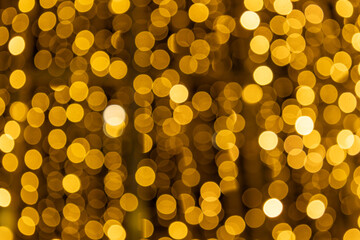 Soft golden bokeh lights create a warm festive background, perfect for Christmas cards, holiday banners, party invitations and elegant seasonal designs with a cozy night atmosphere.