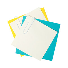 Paper clip holding together a stack of colorful blank papers.