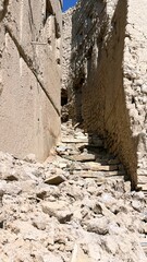 Scout Ascends Broken Pathway Sunlight, Film Scout Navigates Rough Staircase Bathed In Sunlight And Debris, Film Scout Ascends Jagged Staircase Amidst Sunlight And Debris Scattered Along Broken Trail