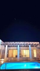 Serene Villa With Illuminated Pool, Modern Residence Features Glowing Nighttime Water Haven, Elegant Modern Home Showcases Radiant Nighttime Pool Set Against Starry Sky Backdrop For Relaxation