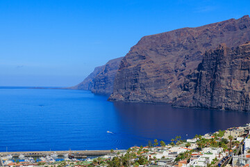 Panorama with vertical cliffs of the Giants (Acantilados de Los Gigantes), townscape of Los Gigantes and Atlantic Ocean at Canary Island Tenerife, Spain