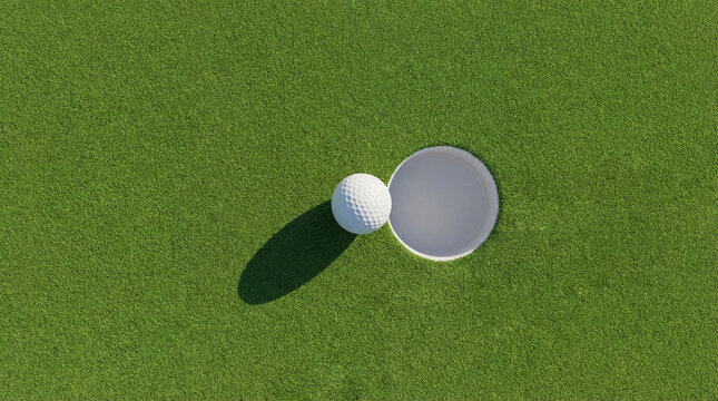 A golf ball sits on the green beside the hole