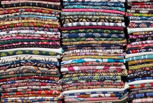 A Store selling traditional Bhagalpur Sarees and Kurtis for Indian women at a city bazaar, market, shopping, vendor, people in India.