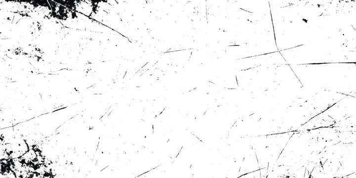 A stark high contrast image showcasing a white grunge surface with scattered dark lines and textures resembling cracks