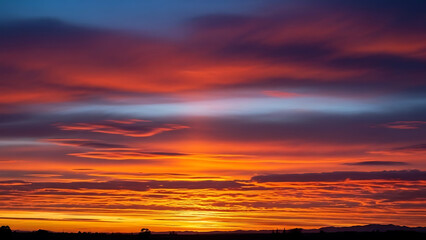 Vibrant Sunset Sky with Orange and Red Clouds Over Horizon Landscape