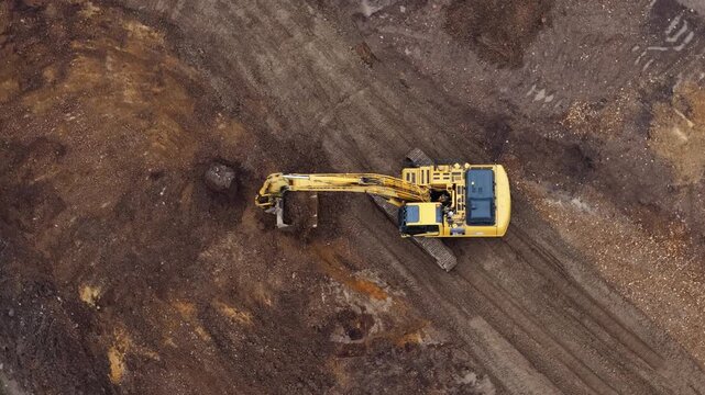 Aerial view of excavator digging dirt